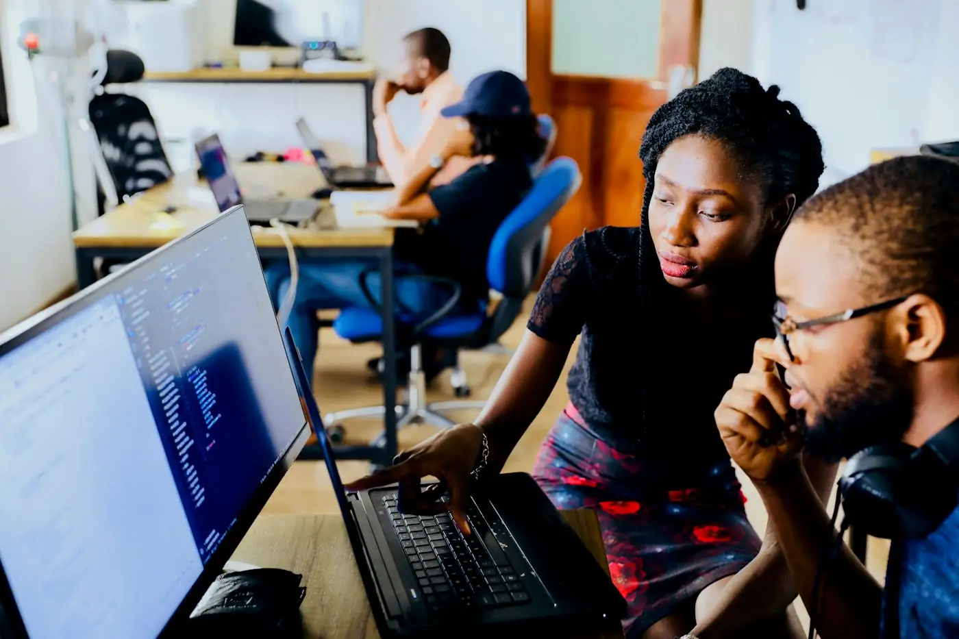 Engineers collaborating at a workstation