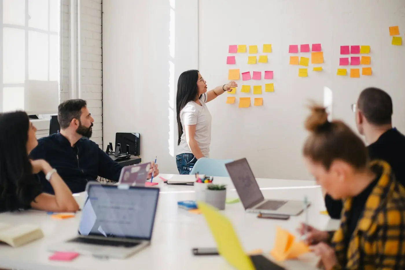 Team mapping an AI roadmap on a wall of sticky notes
